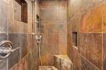 Step into luxury with this stunning shower featuring exquisite tile work and a sleek, modern design.