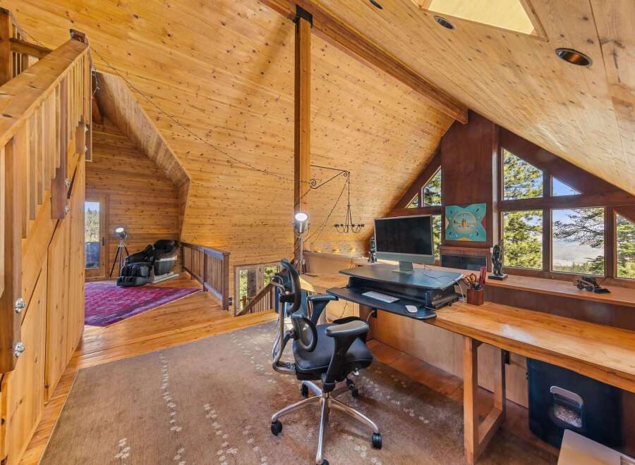 This stunning property features a unique, wood-paneled interior and a spacious loft area perfect for a home office.