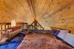 Discover the charm of this unique loft bedroom, featuring a stunning wooden ceiling that adds warmth and character.