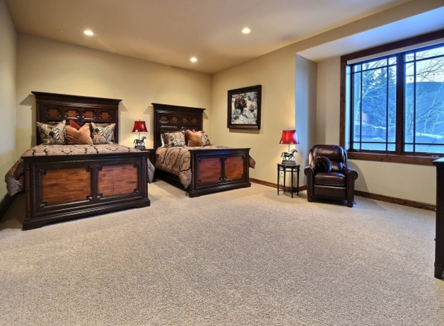 This luxurious bedroom boasts two king-size beds, perfect for guests or a family getaway.