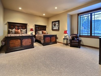 This luxurious bedroom boasts two king-size beds, perfect for guests or a family getaway.