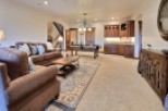 This stunning game room boasts a beautiful pool table, plush seating, and custom cabinetry.