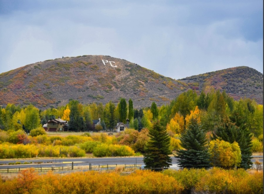 This picturesque property boasts stunning autumn foliage views, with vibrant yellow and orange hues dominating the landscape.