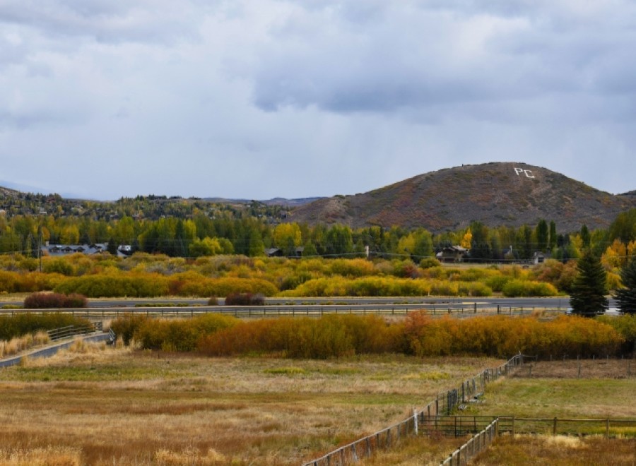 Picturesque property with mountain views and fall foliage.