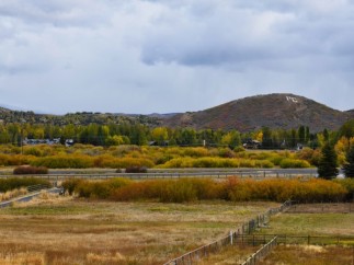 Picturesque property with mountain views and fall foliage.