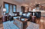 This stunning living room boasts a luxurious leather sectional, perfect for relaxing after a day on the slopes.