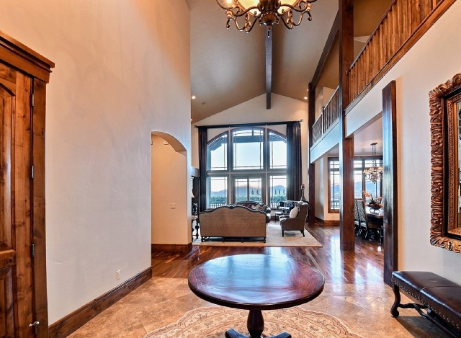 This stunning home boasts a grand two-story entryway with hardwood floors and a beautiful chandelier.