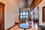 This stunning home boasts a grand two-story entryway with hardwood floors and a beautiful chandelier.