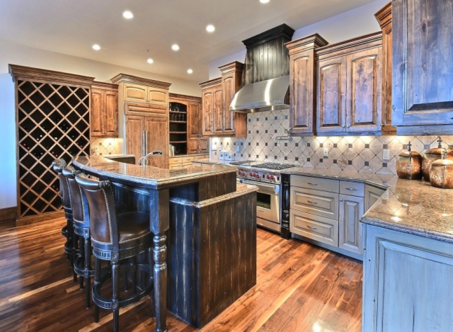This stunning kitchen boasts a custom island with leather barstools, perfect for entertaining.