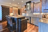 This stunning kitchen boasts a custom island with leather barstools, perfect for entertaining.