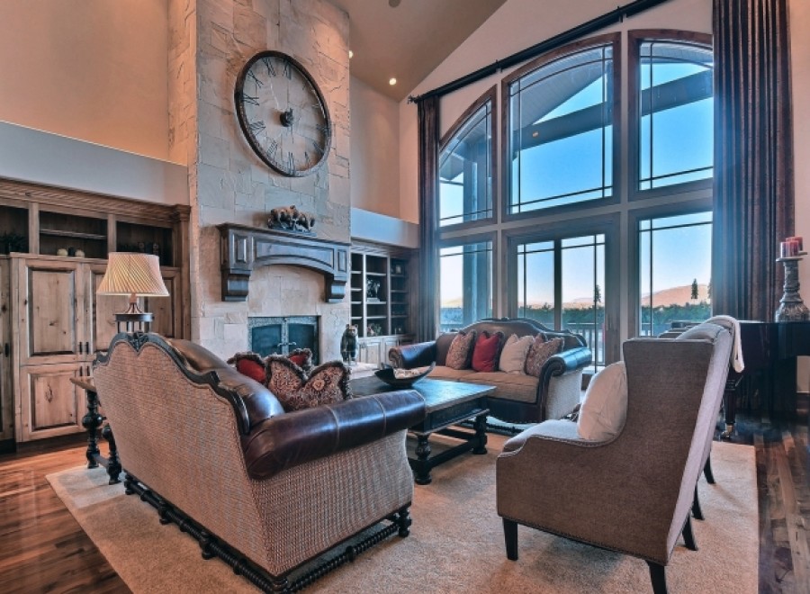 This stunning home boasts a spacious living area with soaring ceilings and expansive windows offering breathtaking views.