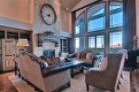 This stunning home boasts a spacious living area with soaring ceilings and expansive windows offering breathtaking views.