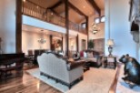 This stunning home boasts a spacious open floor plan with soaring ceilings and a magnificent wooden beam structure.