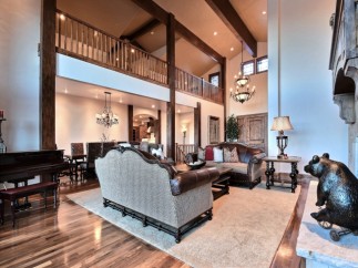 This stunning home boasts a spacious open floor plan with soaring ceilings and a magnificent wooden beam structure.
