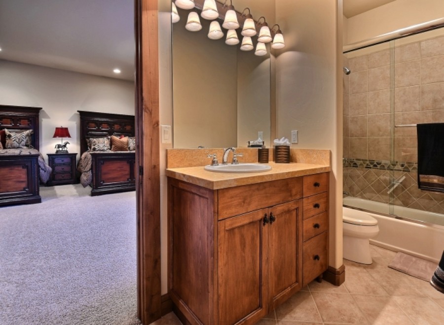 This stunning bathroom boasts a spacious vanity with ample storage, perfect for a relaxing soak.