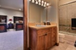 This stunning bathroom boasts a spacious vanity with ample storage, perfect for a relaxing soak.