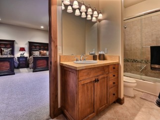 This stunning bathroom boasts a spacious vanity with ample storage, perfect for a relaxing soak.
