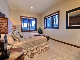 Cozy bedroom with large windows offering scenic views.