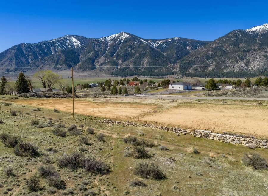 Discover the beauty of this stunning property nestled against a backdrop of majestic mountains.