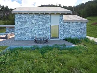 This stunning property boasts a unique stone facade, blending seamlessly with the natural surroundings.