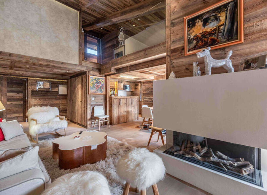 Experience luxury living in this stunning chalet, featuring exquisite wooden interiors and a cozy fireplace.