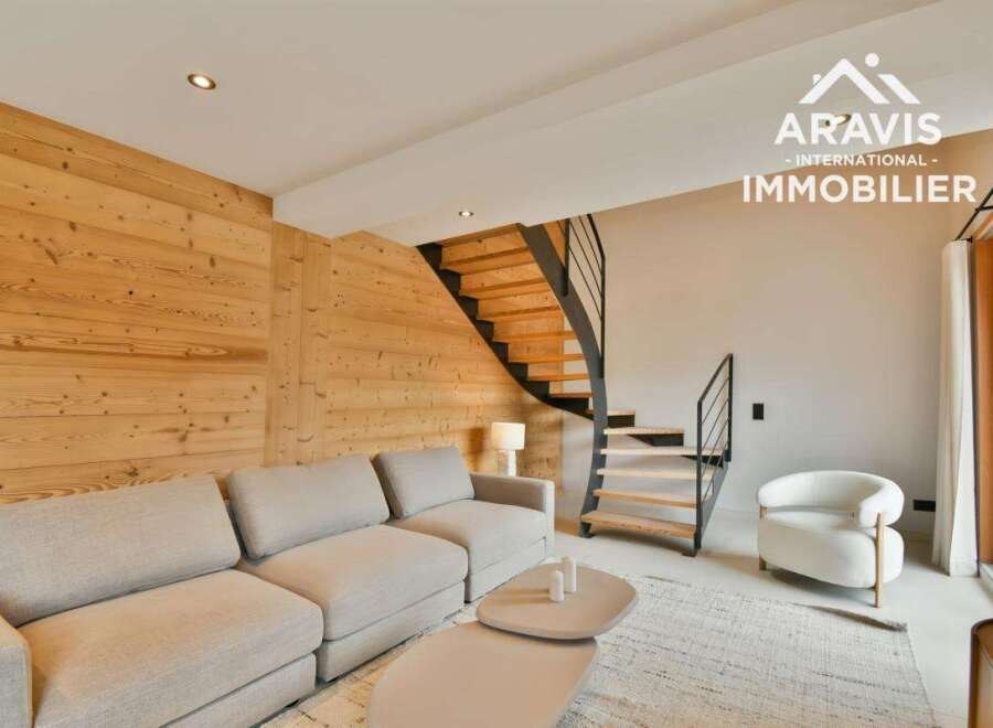 Discover modern living in this stunning property, featuring a stylish interior with a cozy sofa and a unique wooden wall.