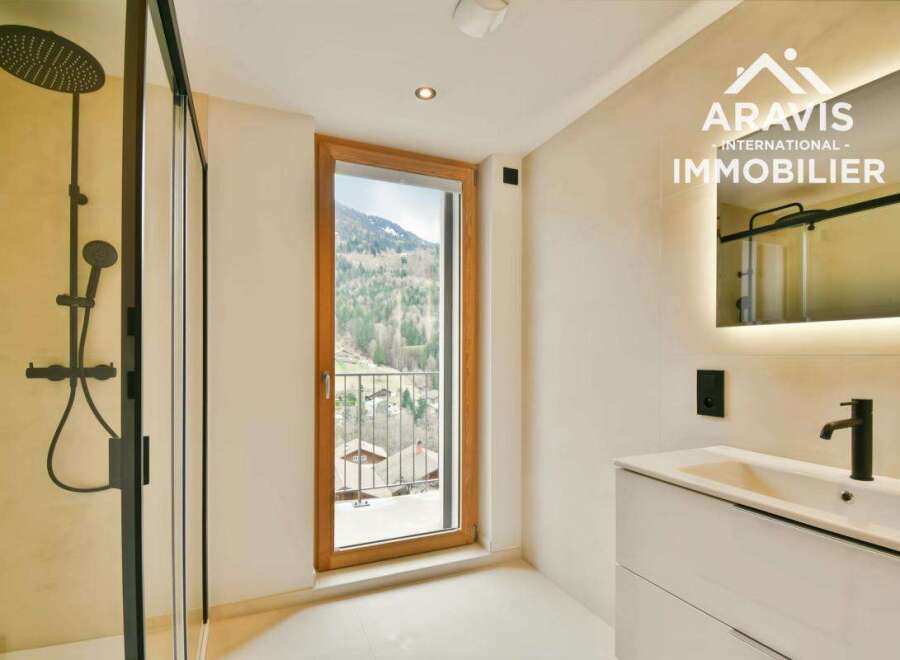 Experience luxury in this stunning bathroom, featuring a sleek shower and a modern vanity.