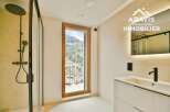 Experience luxury in this stunning bathroom, featuring a sleek shower and a modern vanity.