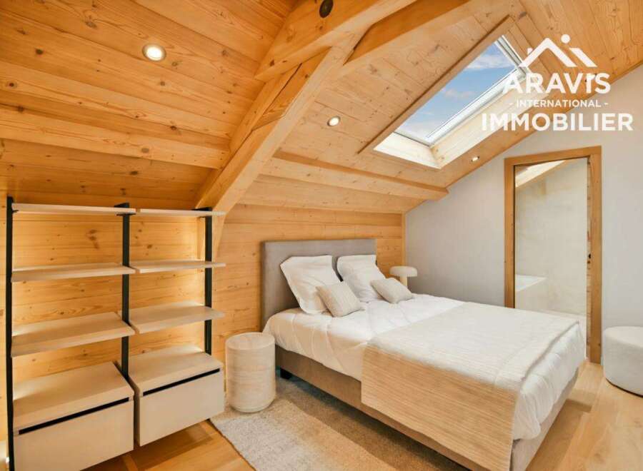 Discover the charm of this stunning bedroom, featuring a unique wooden ceiling and walls that create a warm and inviting atmosphere.