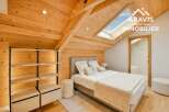 Discover the charm of this stunning bedroom, featuring a unique wooden ceiling and walls that create a warm and inviting atmosphere.