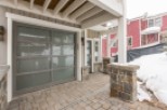 This stunning property boasts a modern gray garage door with frosted glass panels, adding both style and functionality.