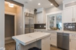 This stunning kitchen boasts a spacious island with quartz countertops, perfect for casual dining or meal prep.