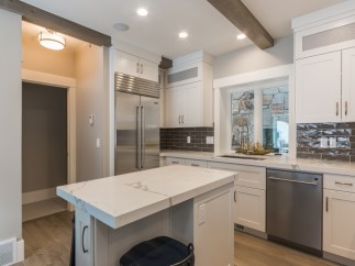 This stunning kitchen boasts a spacious island with quartz countertops, perfect for casual dining or meal prep.