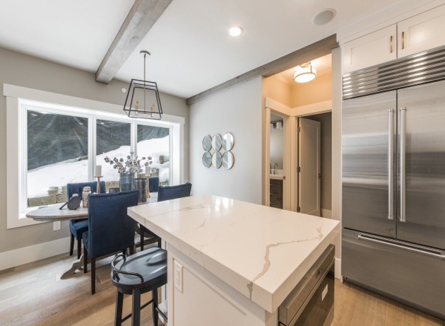 Stunning kitchen with expansive windows overlooking a snowy landscape.