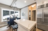 Stunning kitchen with expansive windows overlooking a snowy landscape.