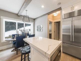 Stunning kitchen with expansive windows overlooking a snowy landscape.