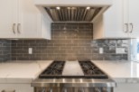 This stunning kitchen boasts a sleek, modern design with high-end stainless steel appliances and a beautiful marble countertop.