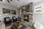 This stunning living room boasts a cozy fireplace, perfect for relaxing evenings.