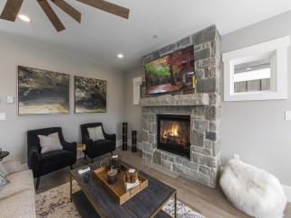 This stunning living room boasts a cozy fireplace, perfect for relaxing evenings.