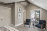 This stunning bedroom boasts a vaulted ceiling with exposed beams, creating an airy and spacious feel.