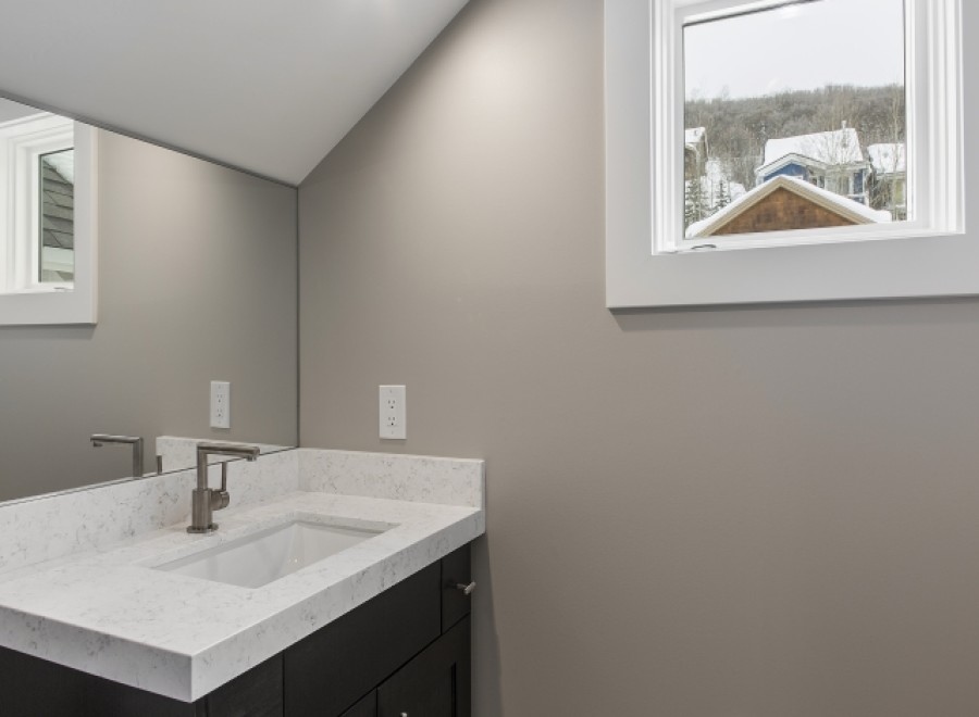 This stunning bathroom boasts a modern vanity with quartz countertops and sleek fixtures.
