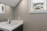 This stunning bathroom boasts a modern vanity with quartz countertops and sleek fixtures.