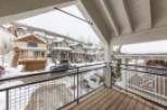 Enjoy breathtaking mountain views from this stunning balcony, complete with a modern metal railing and spacious wooden deck.