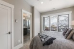 This stunning bedroom boasts a tranquil atmosphere with large windows offering breathtaking mountain views.