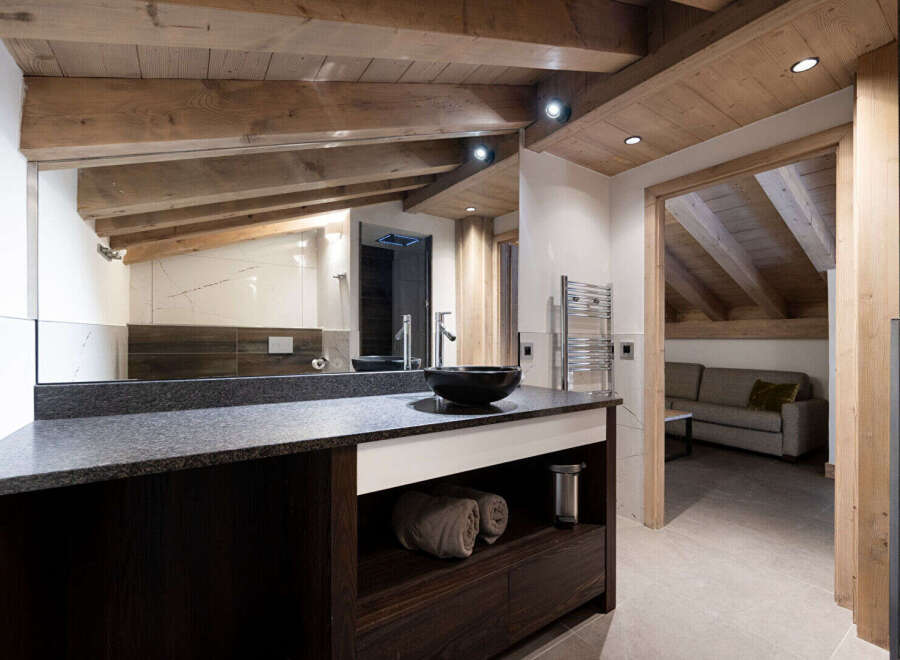 Experience luxury in this stunning bathroom featuring a sleek black countertop and a modern black sink.