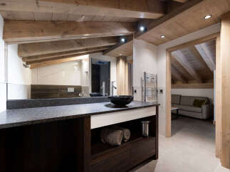 Experience luxury in this stunning bathroom featuring a sleek black countertop and a modern black sink.