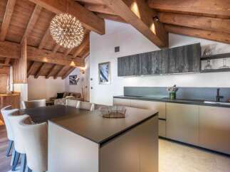 Experience luxury living in this stunning property featuring a modern kitchen with sleek cabinetry and a spacious island.