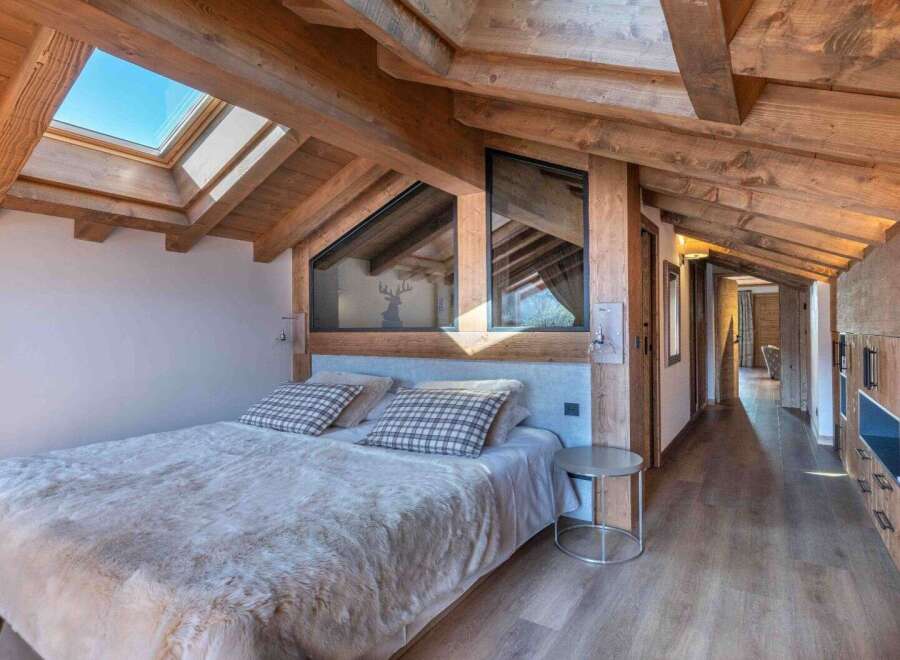 This stunning bedroom boasts a rustic charm with its exposed wooden beams and a cozy, inviting atmosphere.