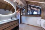 This luxurious bathroom boasts a stunning design with wooden beams and a modern touch.