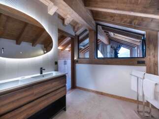 This luxurious bathroom boasts a stunning design with wooden beams and a modern touch.